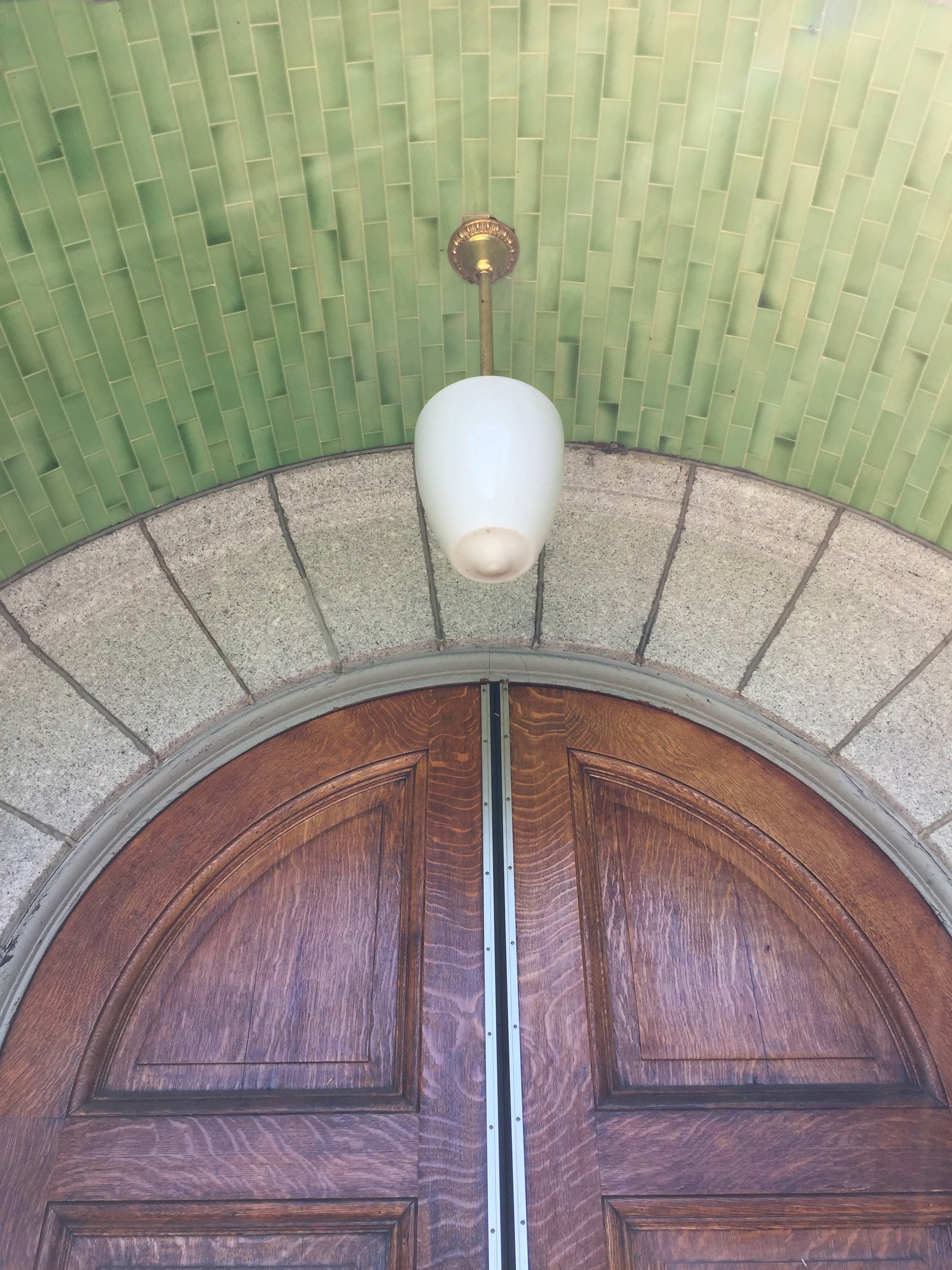 architectural detail with wood door and mosaic ceiling