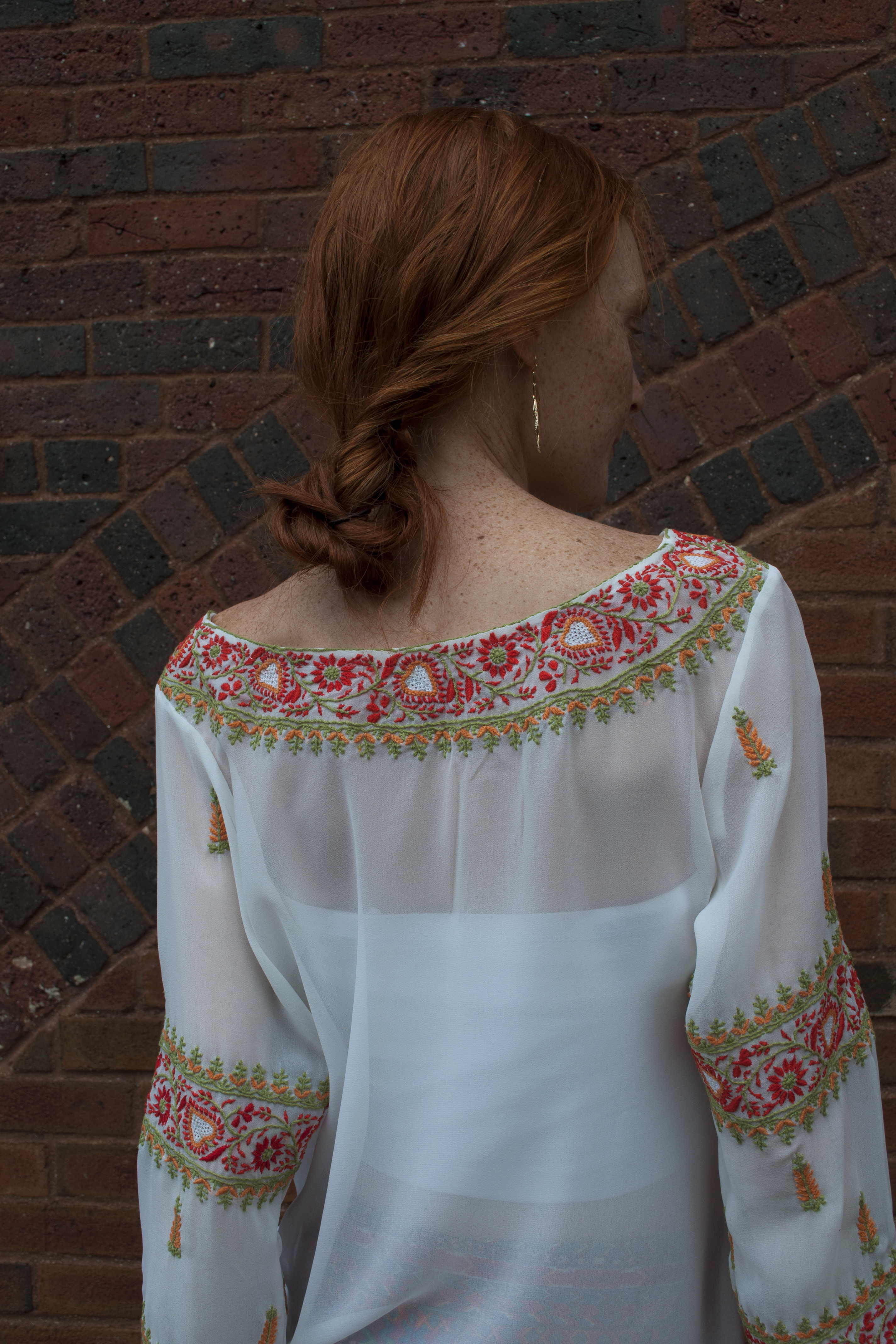 loose updo red hair wearing sheer lace blouse