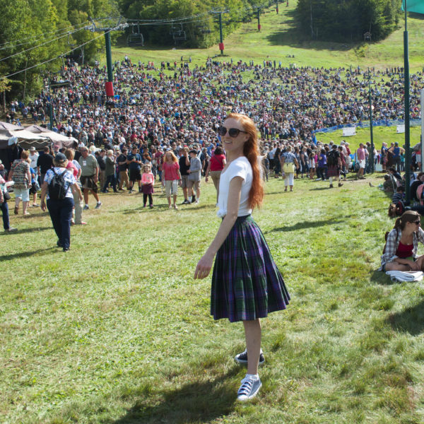 fashion blogger at highland games wearing tartan skirt and converse sneakers