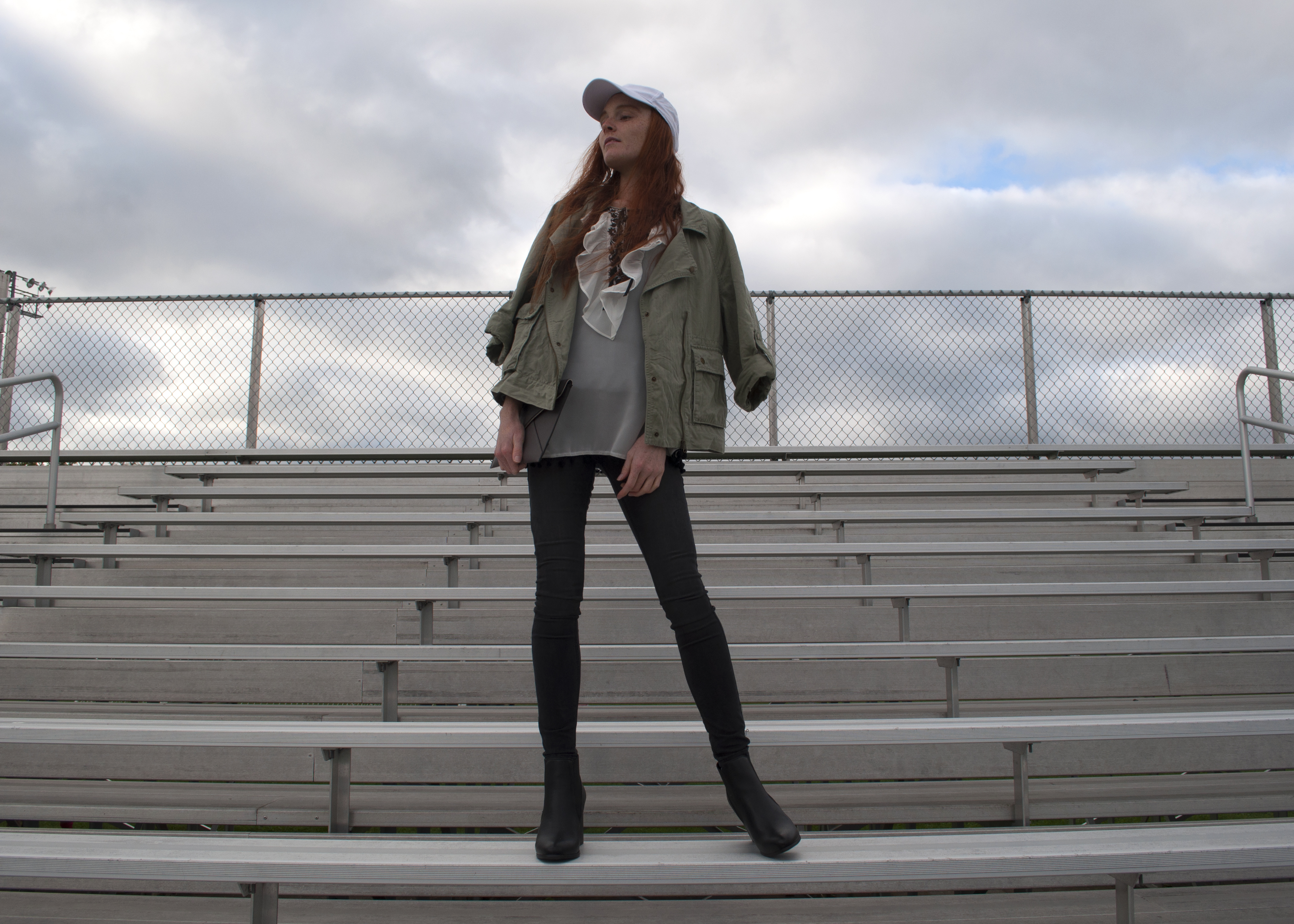fashion blogger in skinny jeans cargo jacket lace and booties