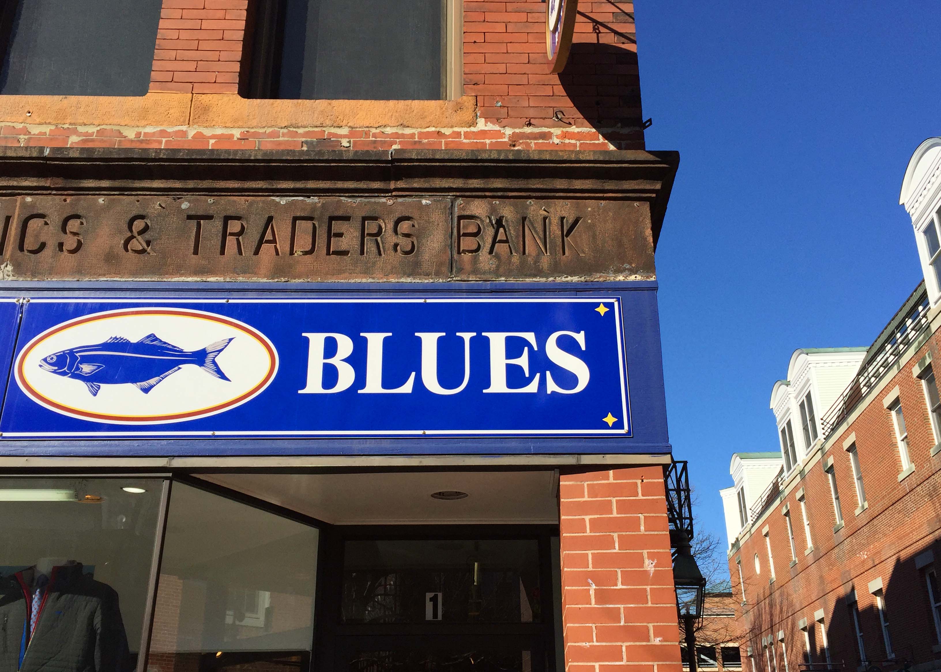 sign with blues on brick building