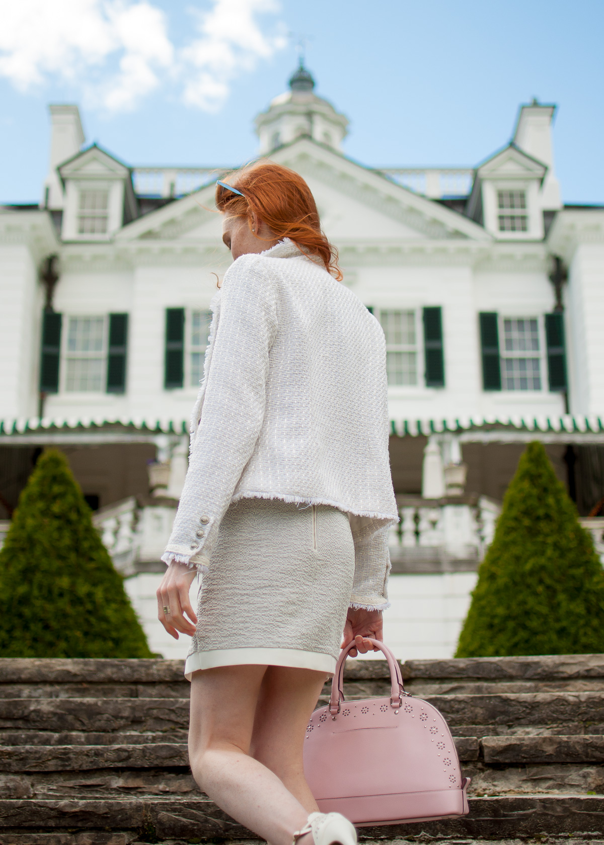 white boucle jacket with textured banana republic skirt and coach bag