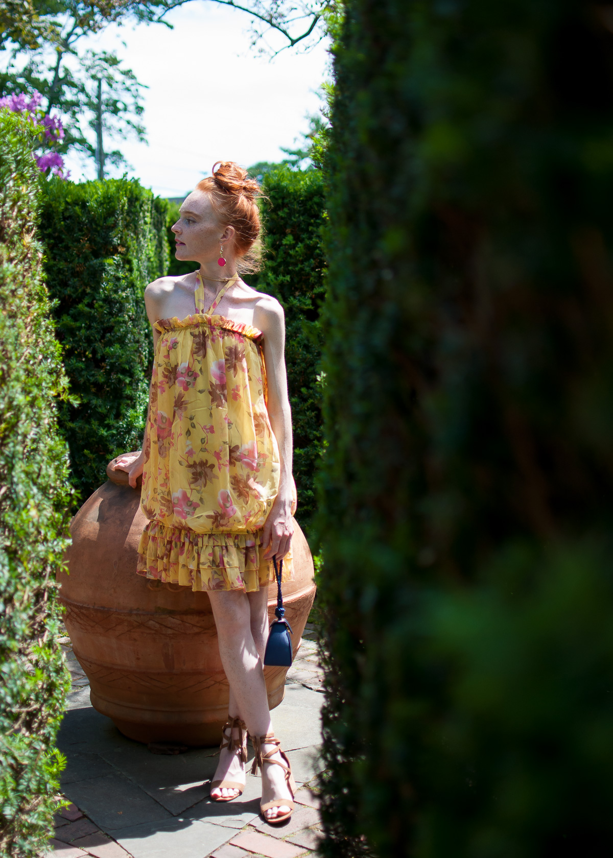 blogger Mary O'Neill wearing yellow summer dress at the gardens of a private estate