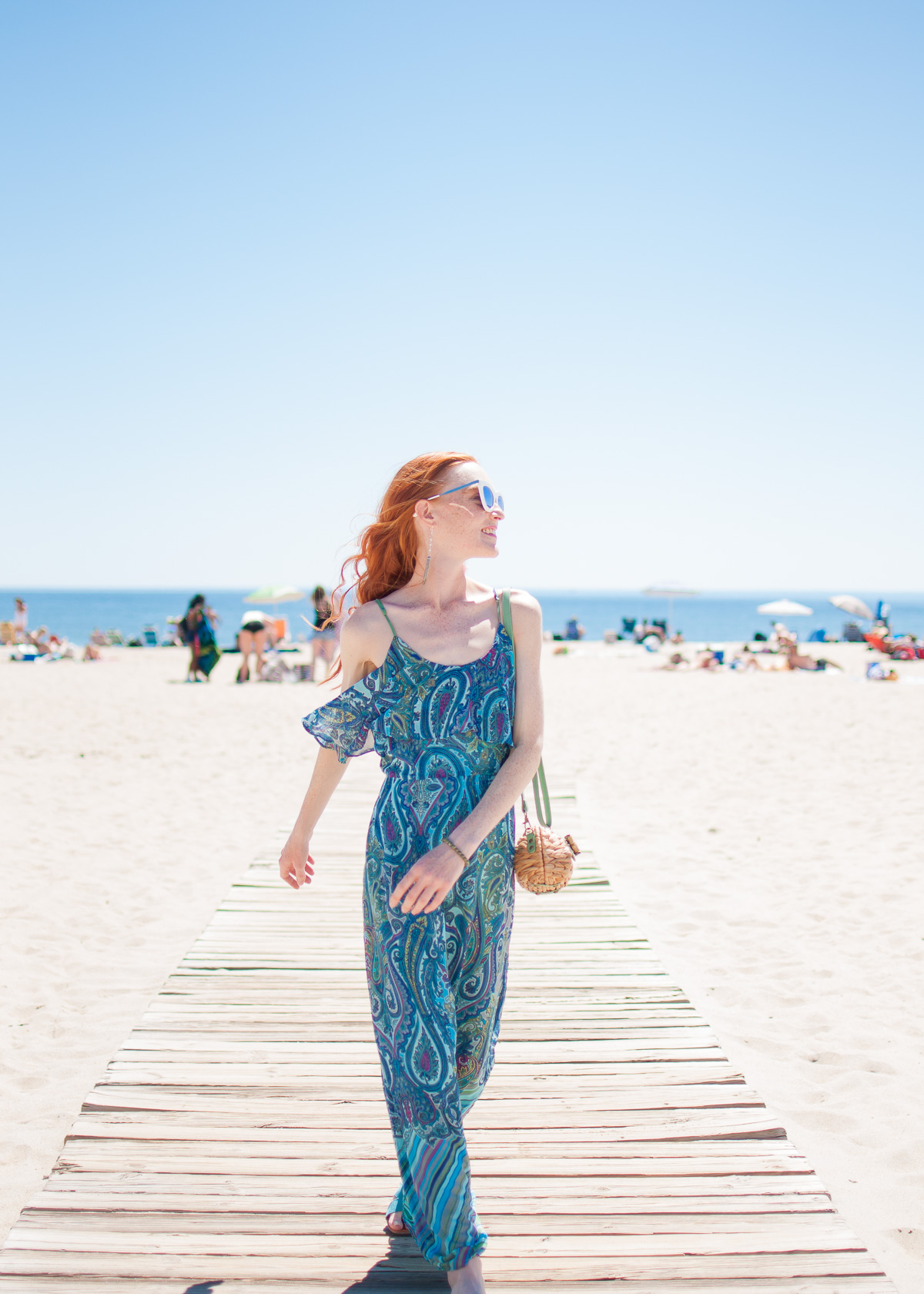 Sandra Darren paisley print maxi dress with Sun N' Sand clutch and Quay Australia sunglasses